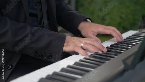 Pianist plays melody on synthesizer at wedding celebration