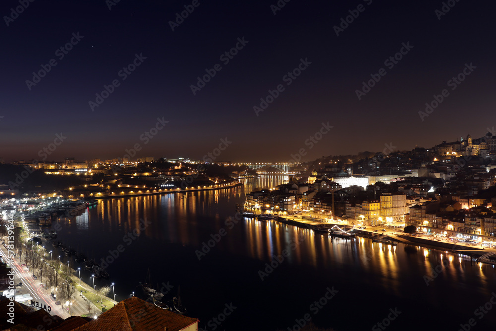 Porto, Portugal old town ribeira aerial promenade view with houses, Douro river and boats
