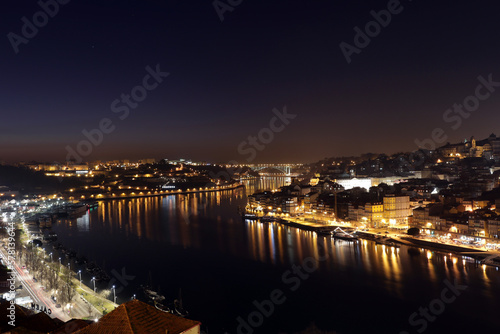 Porto, Portugal old town ribeira aerial promenade view with houses, Douro river and boats 