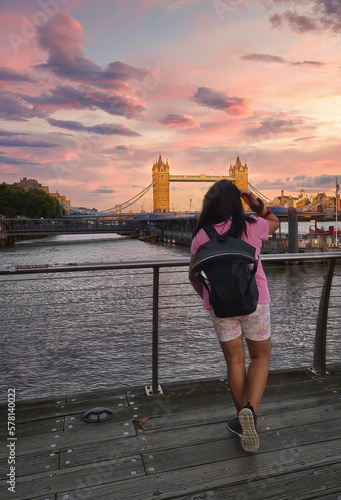 Woman looking at Tower bridge in London, England 