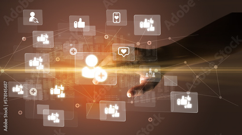 Hand pressing social media multimedia application screen with media icons on futuristic concept
