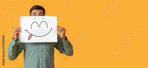 Surprised young man holding...