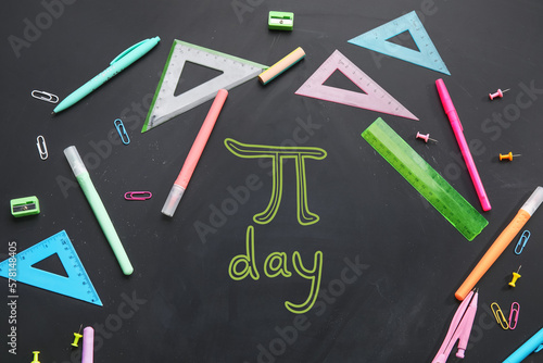Different school stationery and text PI DAY on dark background