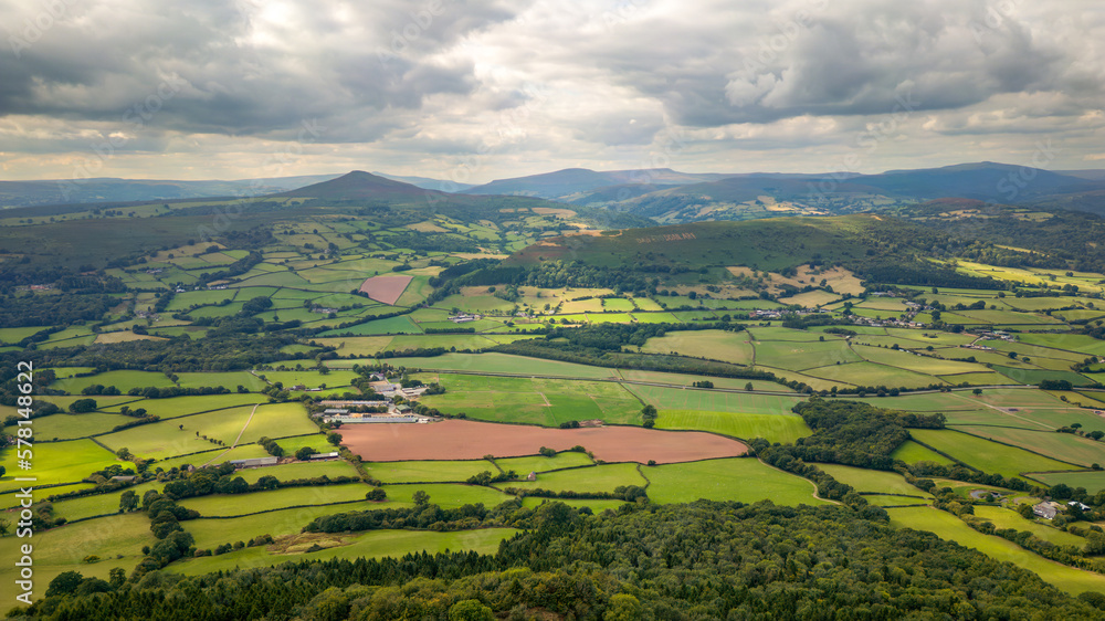 Obraz premium Aerial view of rural farmland and fields in a hilly area (South Wales)