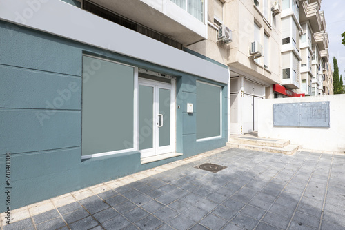 Greyish blue facade of a commercial premises at street level