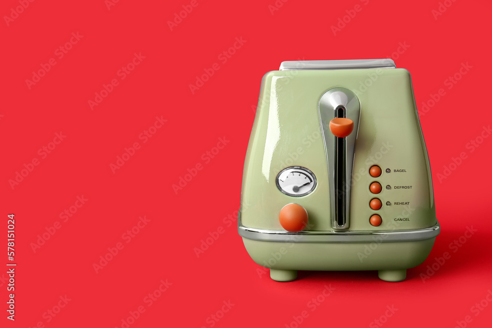 Modern toaster on red background Modern toaster on red background