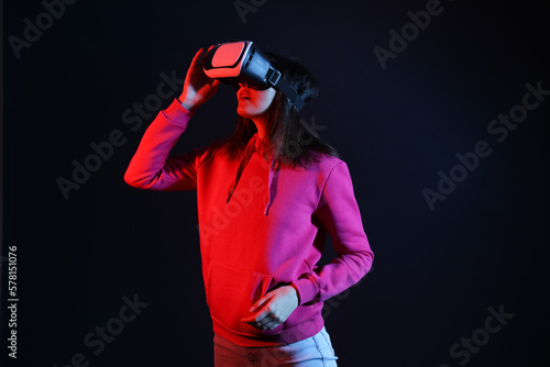 Pretty young woman in VR glasses on black background © Pixel-Shot