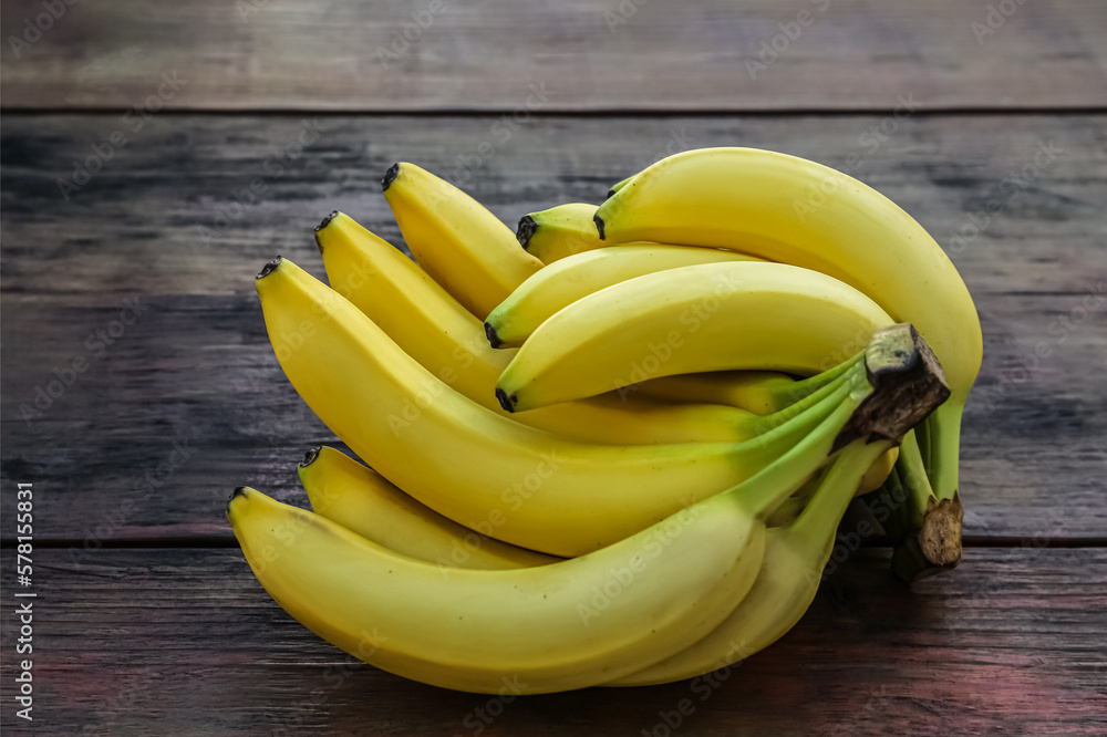 Bunches of ripe yellow bananas on wooden table Bunches of ripe yellow bananas on wooden table
