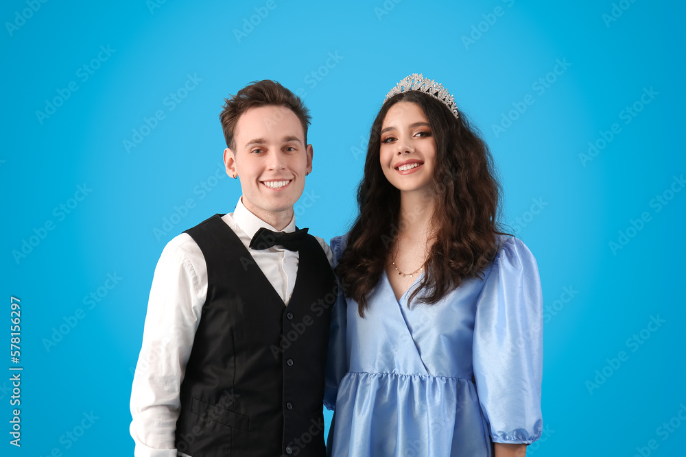 Beautiful couple dressed for prom on blue background Beautiful couple dressed for prom on blue background