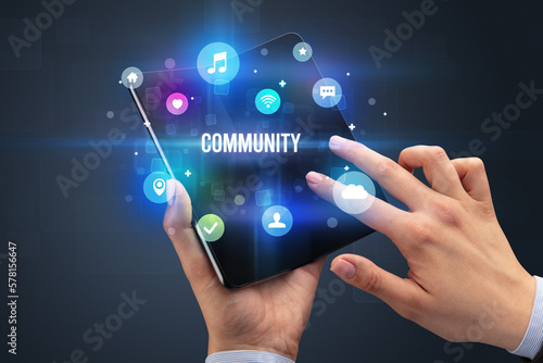 Businessman holding a foldable smartphone