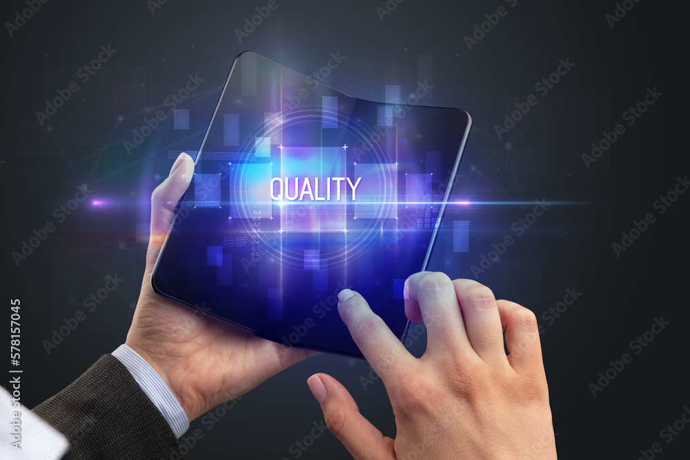 Businessman holding a foldable smartphone Businessman holding a foldable smartphone
