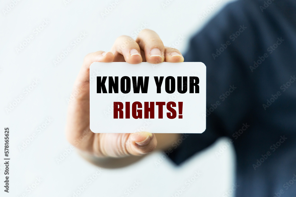 Know your rights text on blank business card being held by a woman's hand with blurred background. Business concept about encouraging people to know their rights. Know your rights text on blank business card being held by a woman's hand with blurred background. Business concept about encouraging people to know their rights.