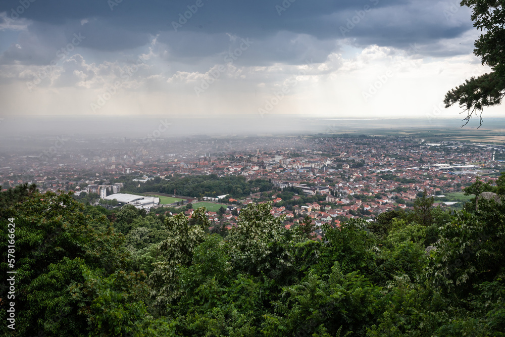 Picture of the city of Vrsac seen from above during a rainstorm, cloudy, Vrsac is a city located in the South Banat District of the autonomous province of Vojvodina, Serbia.