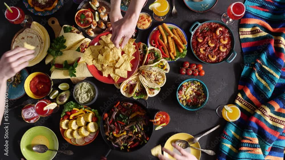 A party in Mexico. Happy family and friends have a fun dinner together at the table. Traditional Mexican cuisine A party in Mexico. Happy family and friends have a fun dinner together at the table. Traditional Mexican cuisine