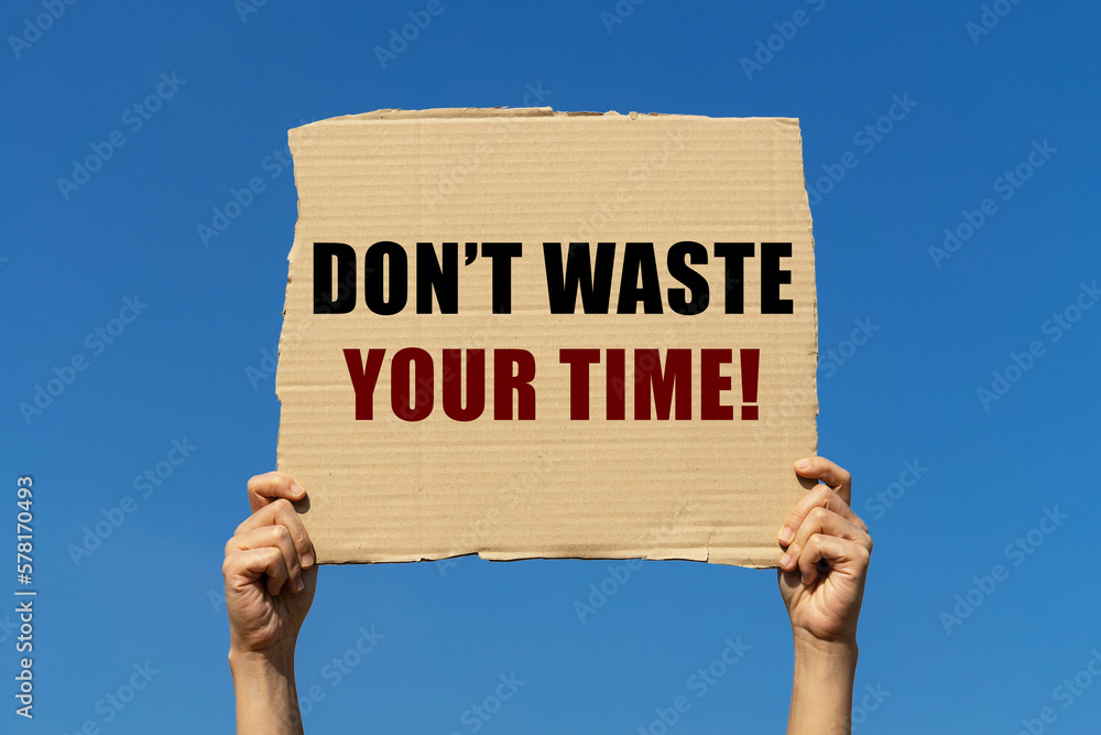 Don't waste your time text on box paper held by 2 hands with isolated