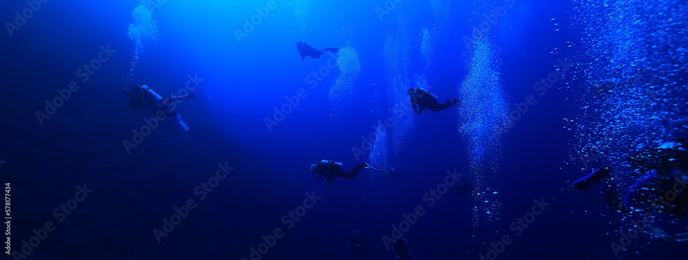 Fototapeta premium group of divers depth bubbles dive