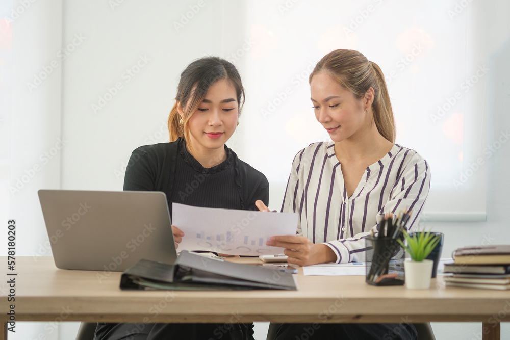 Two young female colleagues working together on new project at office. Two young female colleagues working together on new project at office.