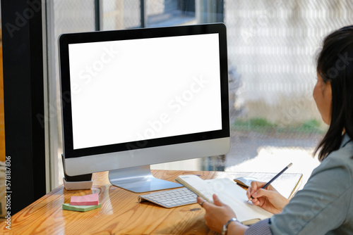 A white screen computer placed on the desk at work. Can put text or media in the area on the white scren