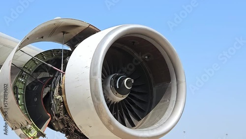 Jet turbine engine of aircraft rotating by wind with blue sky background.Aviation industry  aircraft open engine cover for maintenance. photo