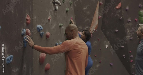 Instructor Teaching Sports People Climbing on Indoor Climbing wall photo