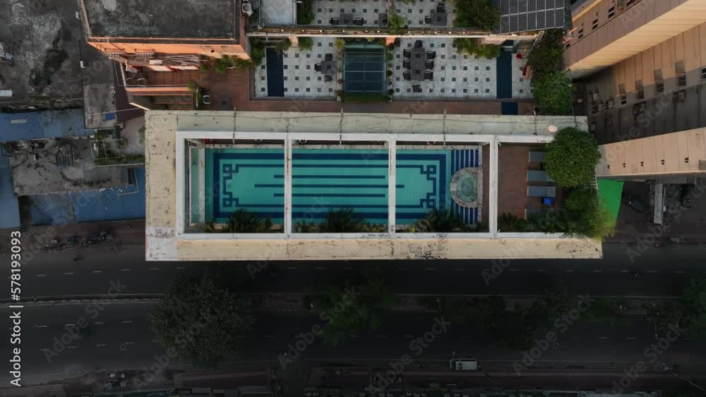 Drone moves straight up, away from the rooftop swimming pool in Dhaka. Bangladesh. Drone moves straight up, away from the rooftop swimming pool in Dhaka. Bangladesh.