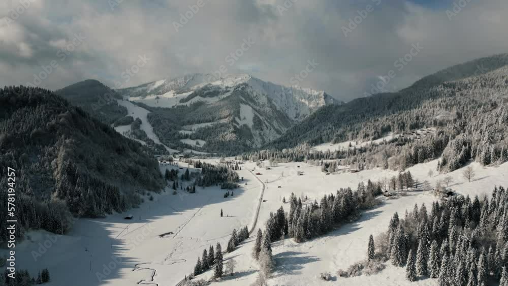 Drone aerial view flying over picturesque mountain ridge snowy landscape with snow, sunlight and blue sky. Empty cinematic alpine winter scenery valley in Austria Bavaria alps mountains 4K documentary Drone aerial view flying over picturesque mountain ridge snowy landscape with snow, sunlight and blue sky. Empty cinematic alpine winter scenery valley in Austria Bavaria alps mountains 4K documentary