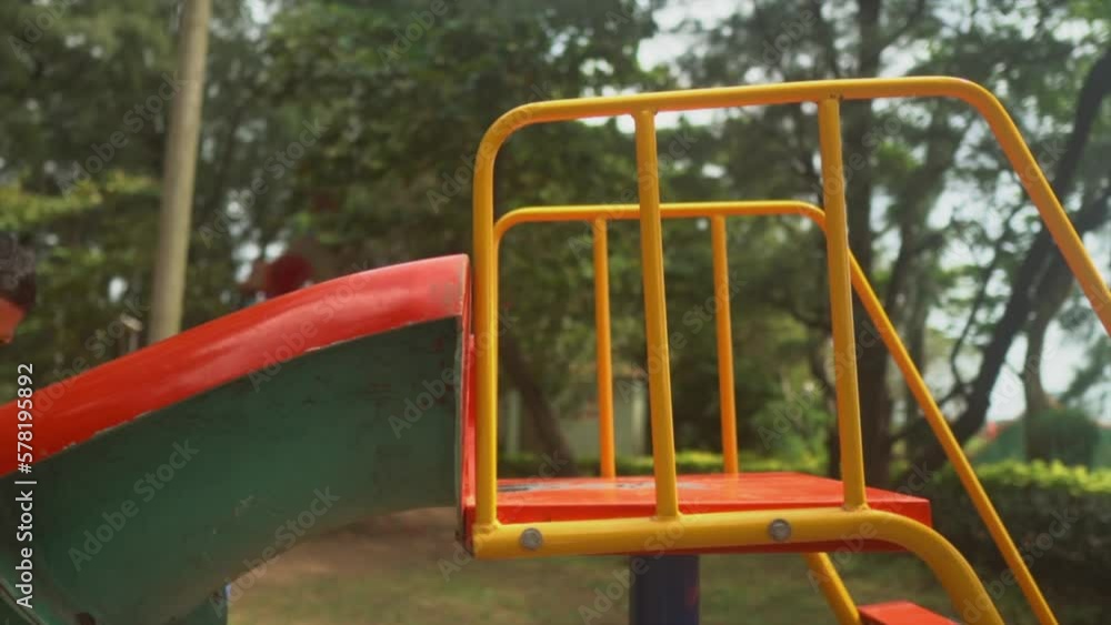 Small children playing on a slide in a playground painted in colors. Small children playing on a slide in a playground painted in colors.