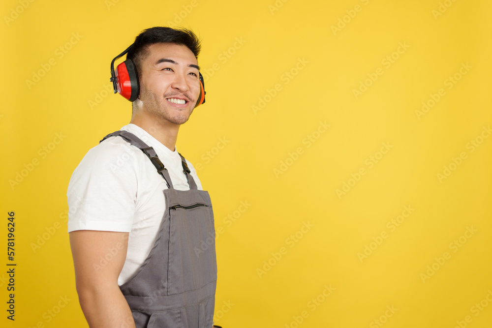 Chinese carpenter smiling distracted while looking up Chinese carpenter smiling distracted while looking up