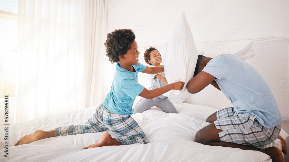 Fototapeta premium Black family, pillow fight and bedroom bonding of a father, children and fun in a home. Papa, kids and crazy play fighting of youth with energy in the morning in a house with dad feeling love
