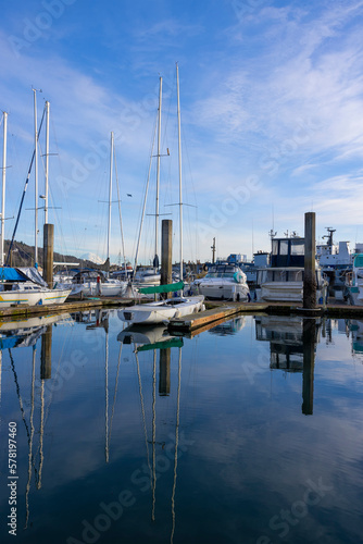 Marina, yacht parking, sailboats. Reflection on the water.