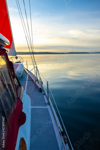 Traveling on a yacht on the ocean, a multi-colored sailboat. Sunset
