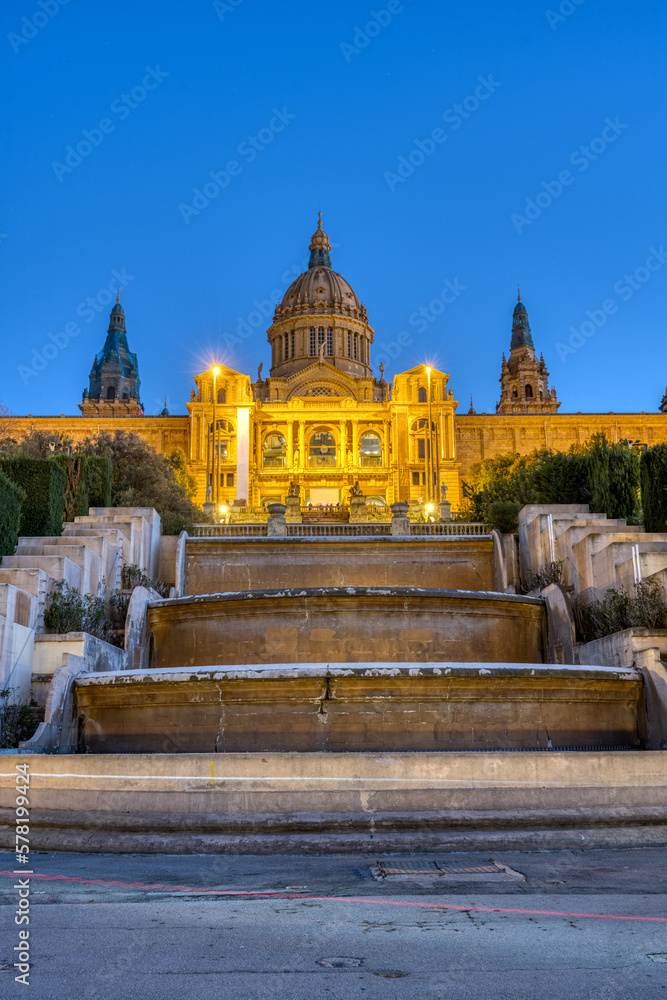 Naklejka premium The National Palace on Montjuic mountain in Barcelona illuminated at twilight