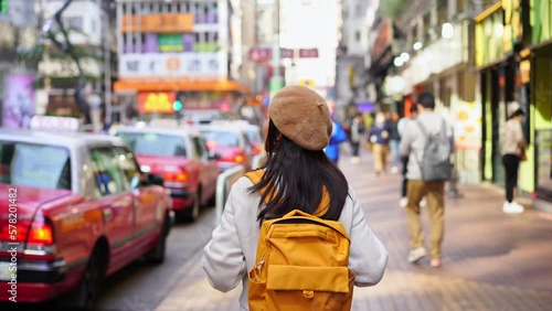 Young woman traveler walking in the Mong Kok in Hong Kong, Mong Kok is one of the major shopping areas in Hong Kong