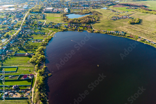 View from a height of a large rounded lake. Lake Komlevo, Borovsky district, Kaluzhskiy region, Russia