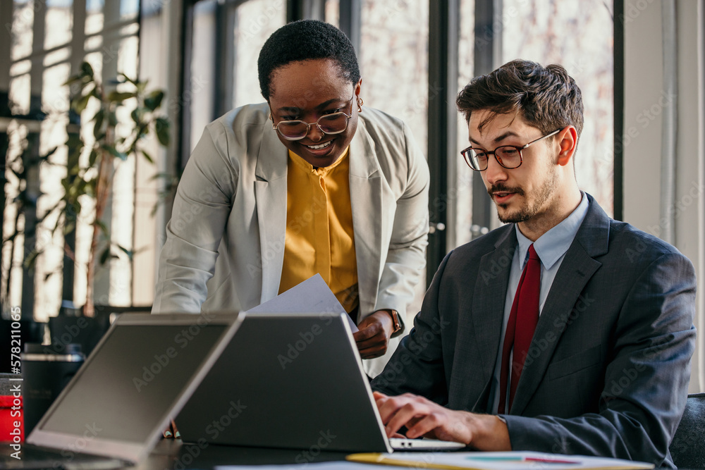 Business coworkers working together at office. Diverse people working in the bright office.