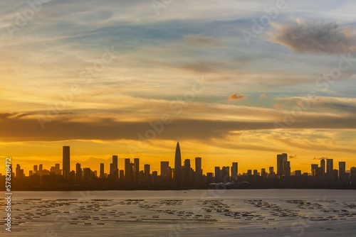 Panorama of silhouette of skyline of Shenzhen city, China at sunset. Viewed from Hong Kong border © leeyiutung