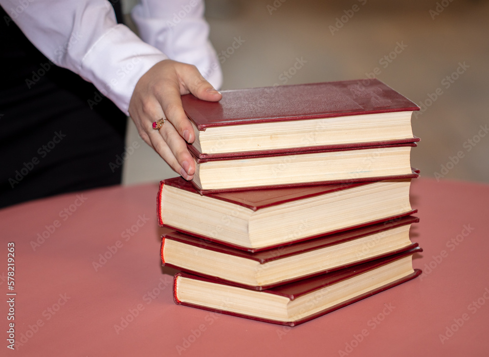 Girl's hands with books in the library. Girl's hands with books in the library.