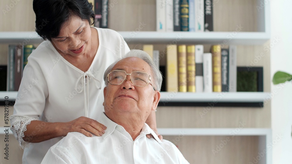 Fototapeta premium Loving Asian senior couple relaxing and sitting on sofa at home. Happy senior retirement lifestyle