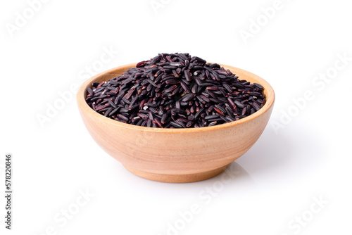 Black rice in wooden bowl isolated on white background. Clipping path.