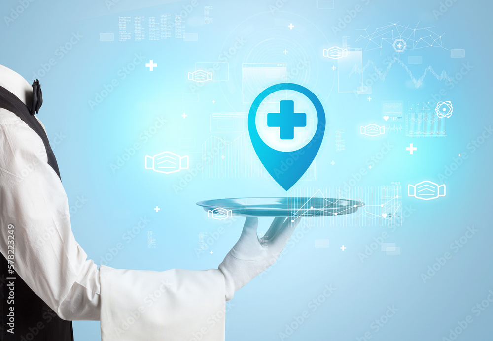 Handsome young waiter in tuxedo holding healthcare icons on tray