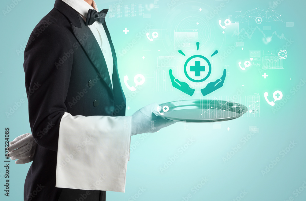 Handsome young waiter in tuxedo holding healthcare icons on tray Handsome young waiter in tuxedo holding healthcare icons on tray