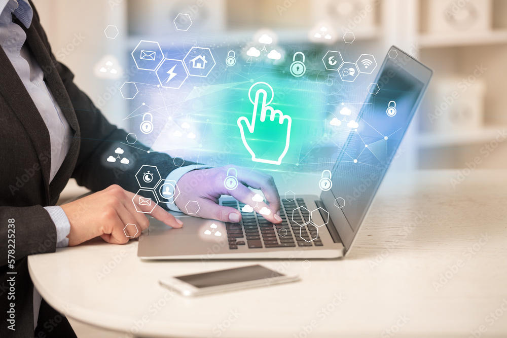 Hands working on laptop with digital icons Hands working on laptop with digital icons