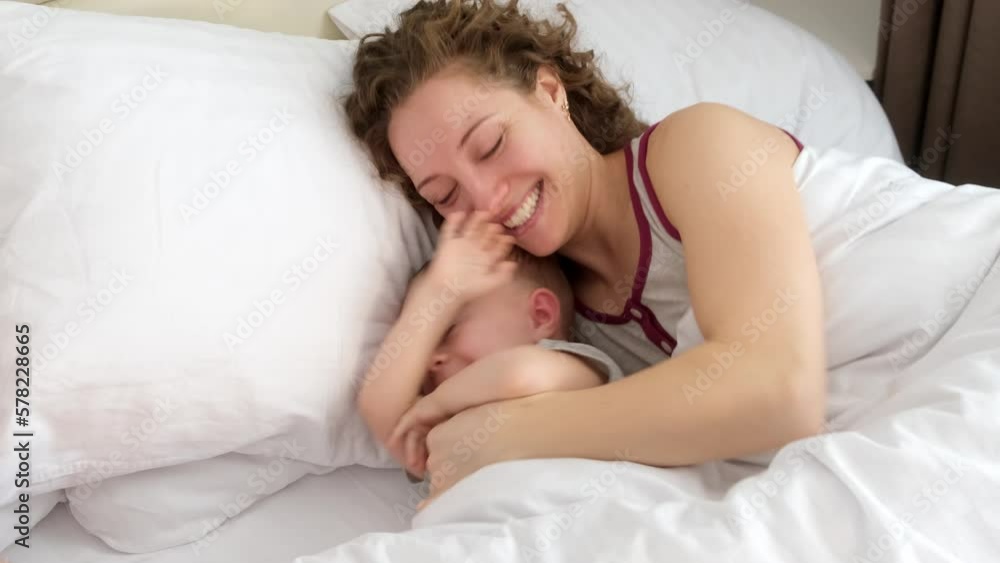 Close up portrait of a mother and her daughter who sleeps in mom's arms Close up portrait of a mother and her daughter who sleeps in mom's arms