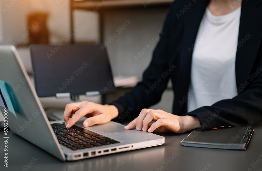 Businesswoman hand using smart phone laptop and tablet with social network diagram on desk as concept in morning light.. Businesswoman hand using smart phone laptop and tablet with social network diagram on desk as concept in morning light..