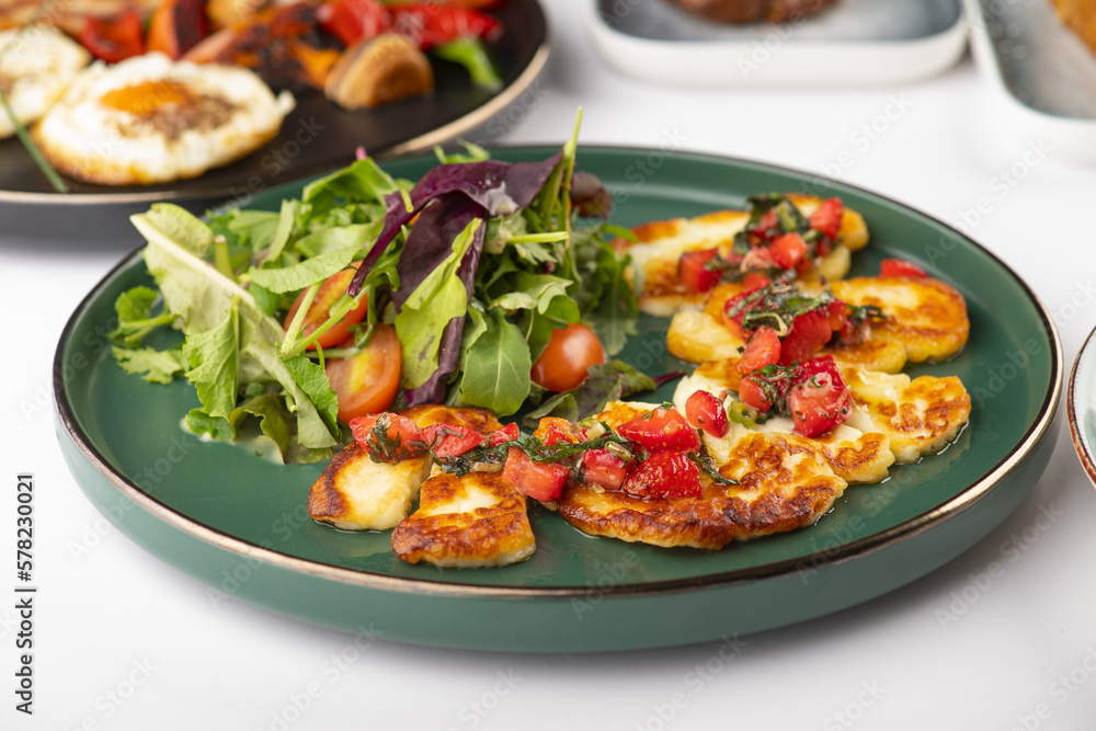 Grilled Halloumi cheese served with a green salad Grilled Halloumi cheese served with a green salad