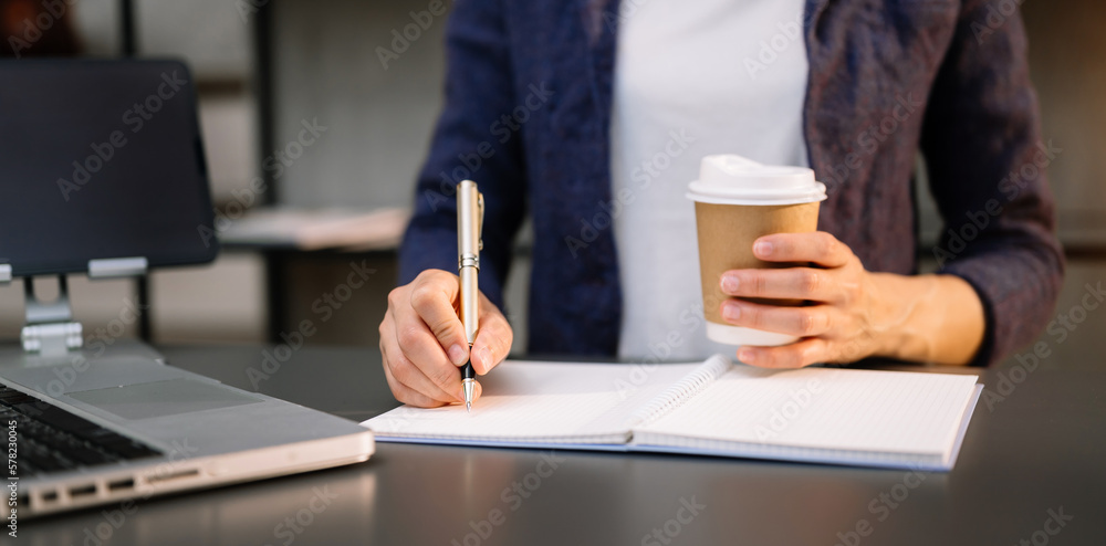 Businesswoman hand using smart phone laptop and tablet with social network diagram on desk as concept in morning light.. Businesswoman hand using smart phone laptop and tablet with social network diagram on desk as concept in morning light..