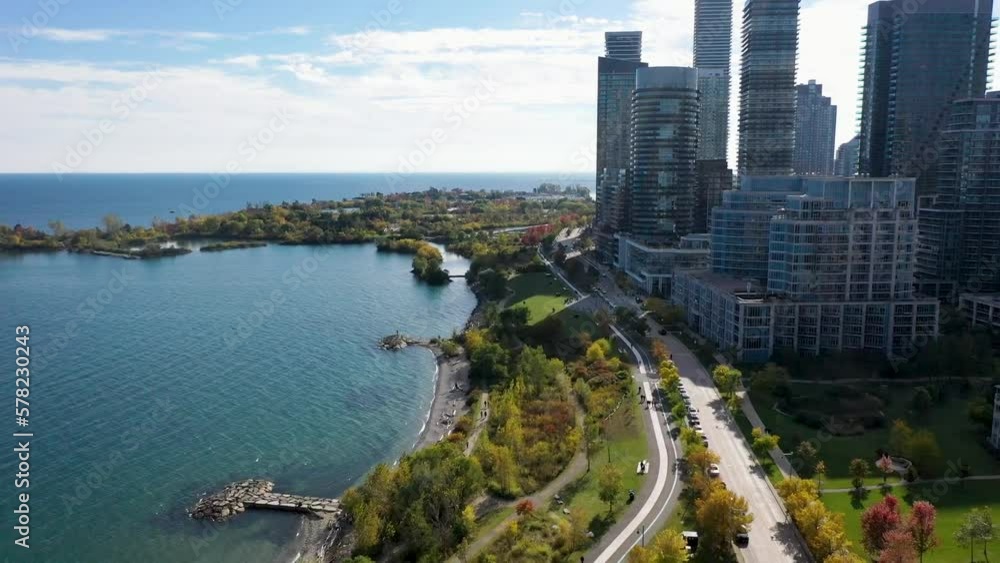 Drone flying along the sunny coastline of Lake Ontario with apartment buildings in Toronto. Drone flying along the sunny coastline of Lake Ontario with apartment buildings in Toronto.