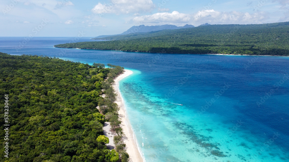 Aerial view of remote, uninhabited Jaco Island and mainland Timor Leste, Southeast Asia, tropical island destination with white sandy beaches and stunning turquoise ocean views