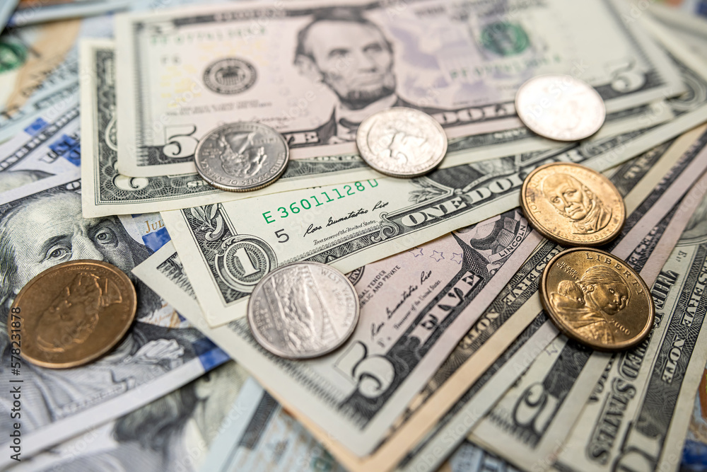 different United States dollar bills with coins for background different United States dollar bills with coins for background