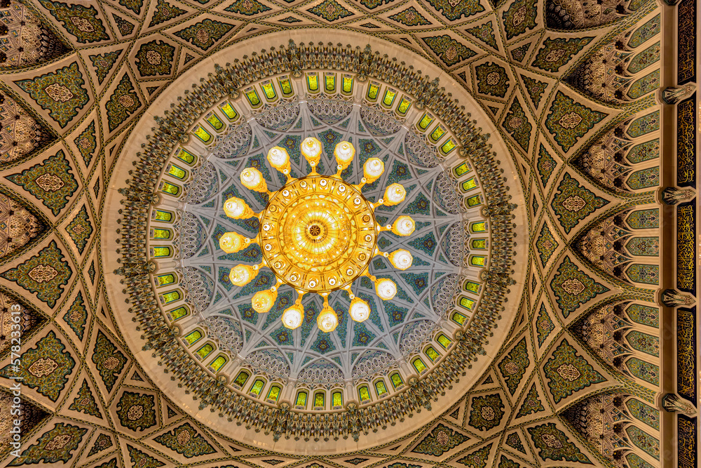 View of ceiling and chandelier of of  Sultan Qaboos grand Mosque, giving details of artwork that combines the traditional Islamic motifs and calligraphy, Muscat, Oman